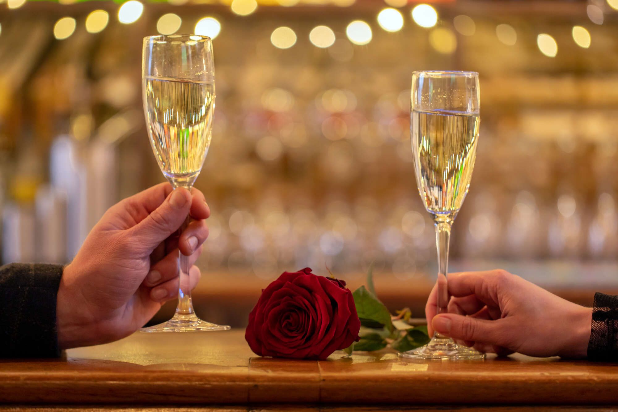 2 glasses of sparkling wine with a rose