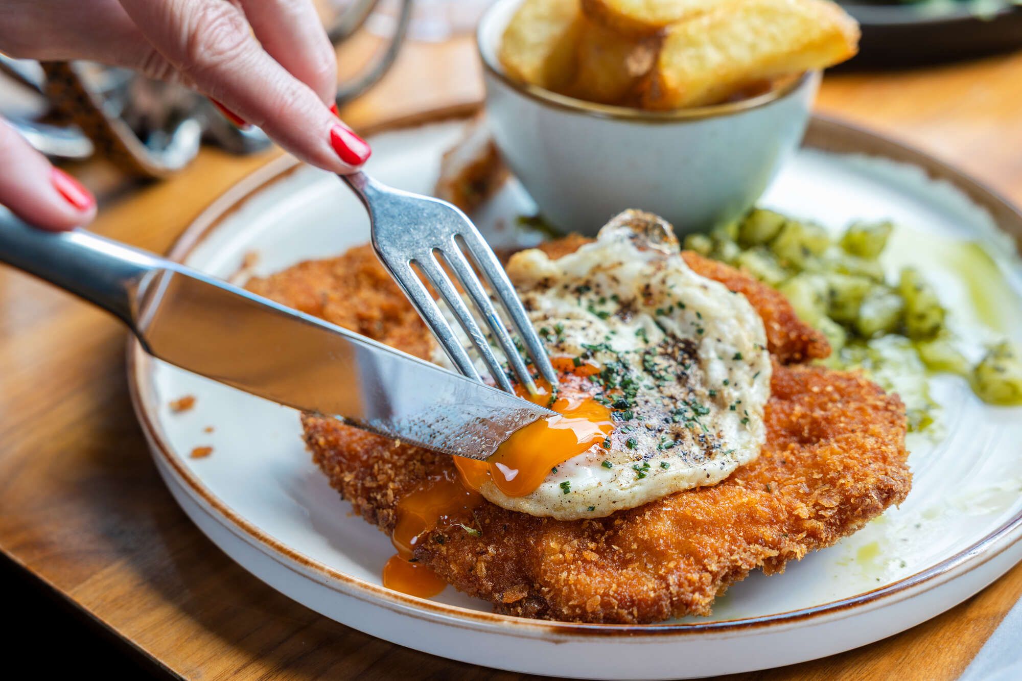 schnitzel topped with a runny fried egg